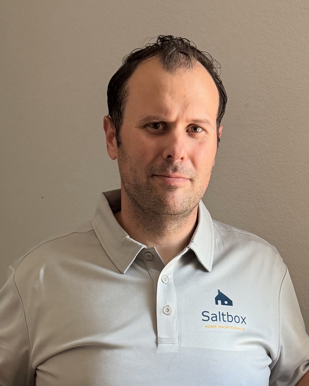 Jared Miller, founder of Saltbox Home Maintenance, in a Saltbox polo shirt